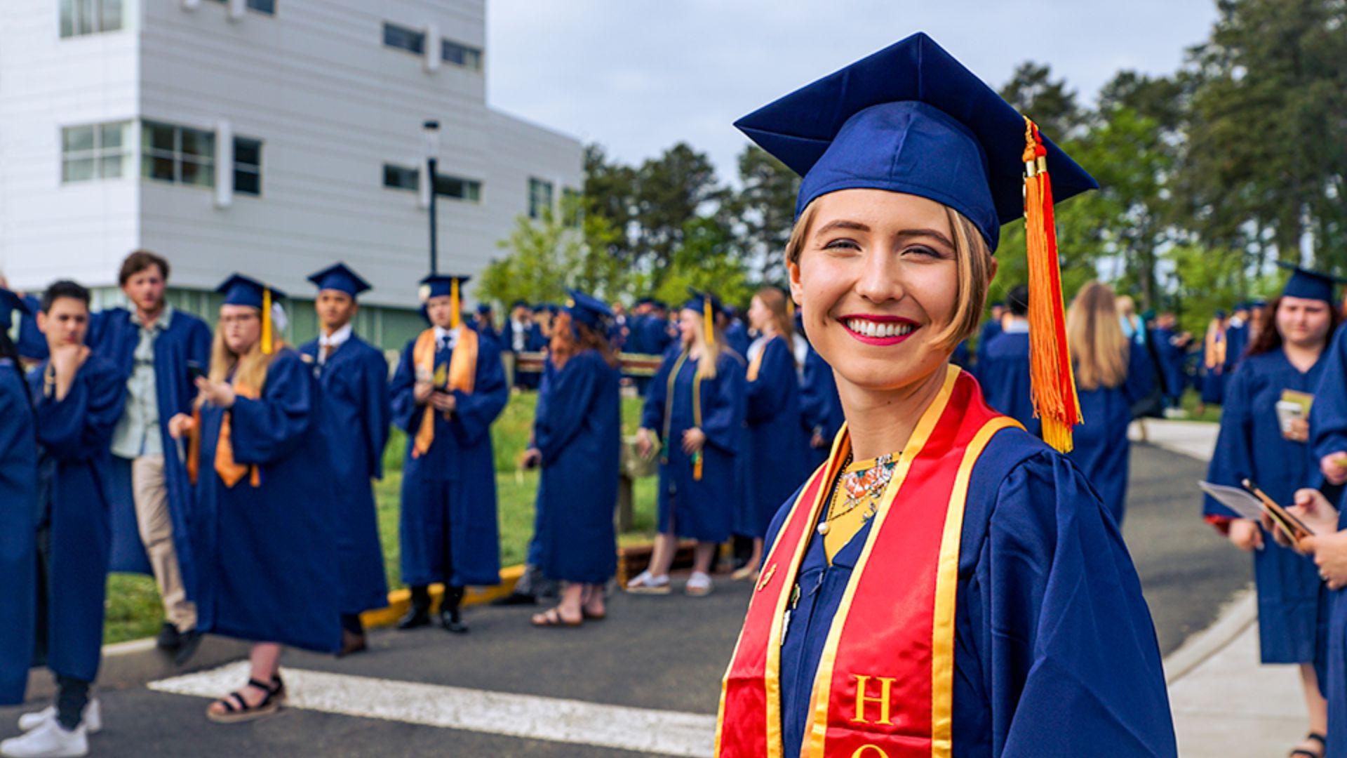 Graduating Student in attire waiting in line with peers